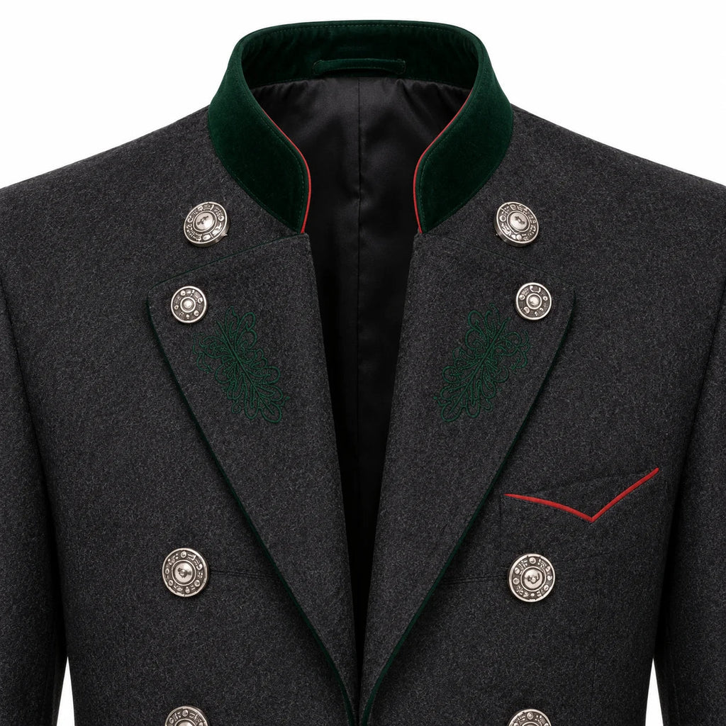 Close-up of a dark gray textured double-breasted coat with a green velvet collar, silver buttons, and red piping details.