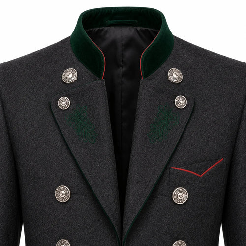 Close-up of a dark gray textured double-breasted coat with a green velvet collar, silver buttons, and red piping details.