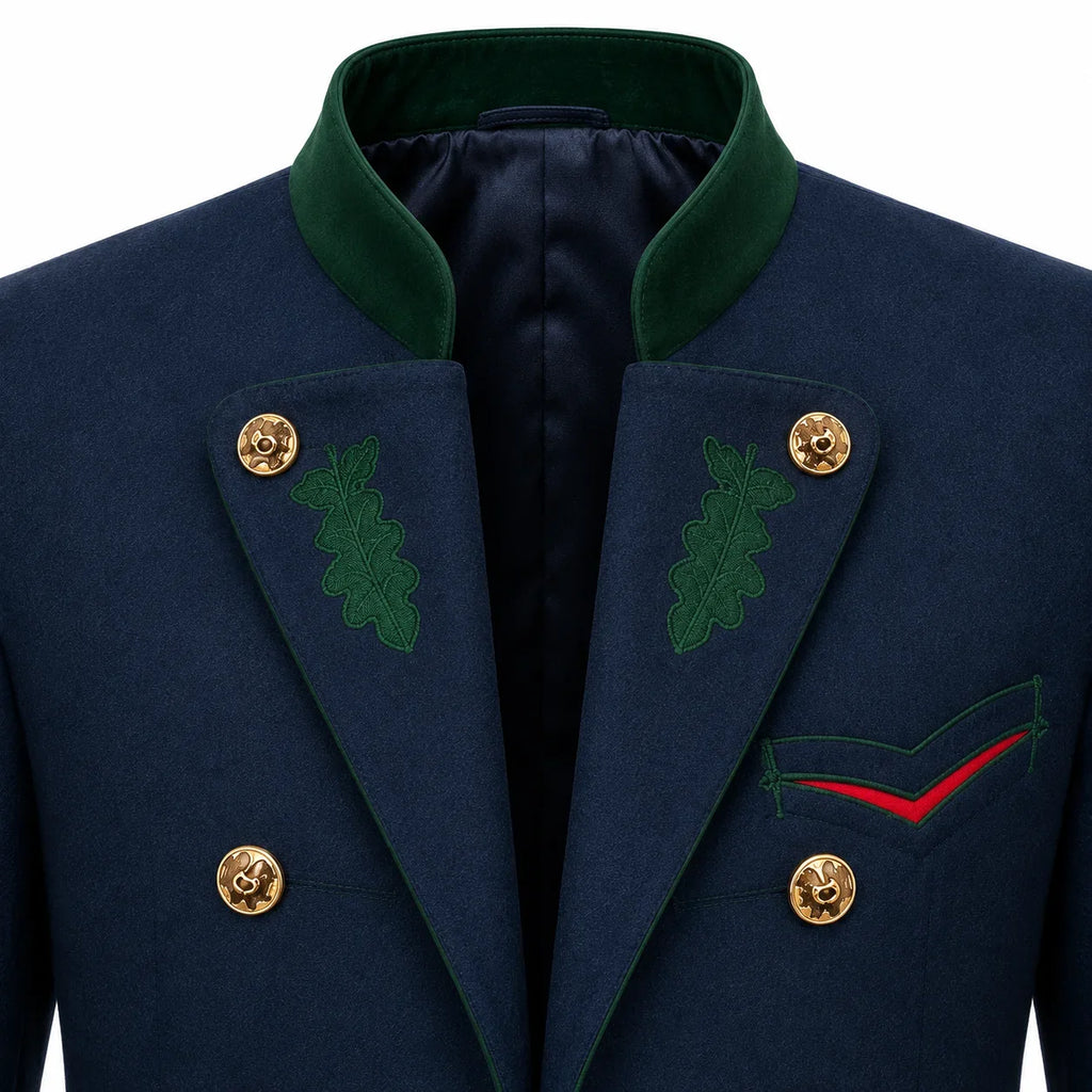 Close-up of a navy double-breasted blazer with a dark green peak collar, green embroidered oak leaf details on the lapels, gold buttons, and a red accent line on the chest pocket.