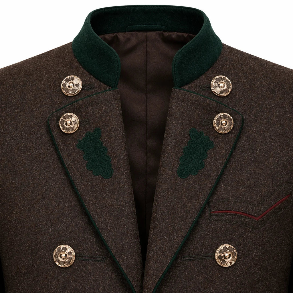 Close-up of a dark brown textured wool coat with a dark green velvet collar, green embroidered leaf details on the lapels, and ornate gold buttons.