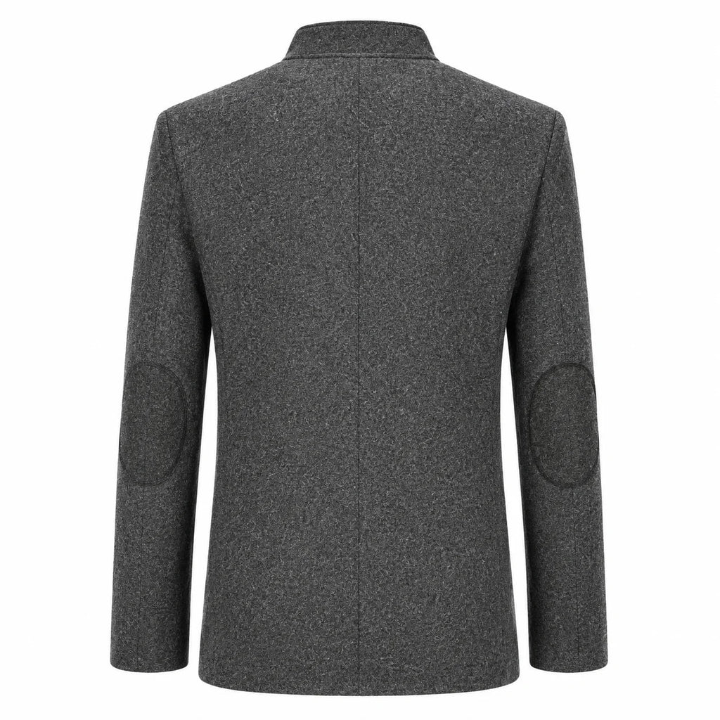 A dark gray textured wool-blend blazer shown from the back, featuring circular patchwork elbow patches on the sleeves and a clean collar.