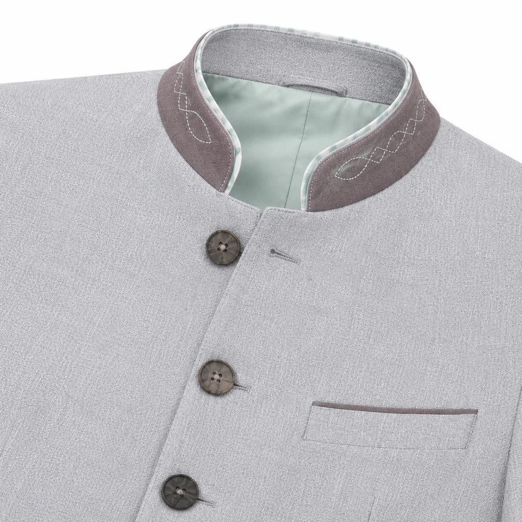 Close-up of a light gray textured jacket with a mandarin collar, featuring a contrasting brownish-gray inner collar with white embroidery, a pale green lining, and three dark buttons.