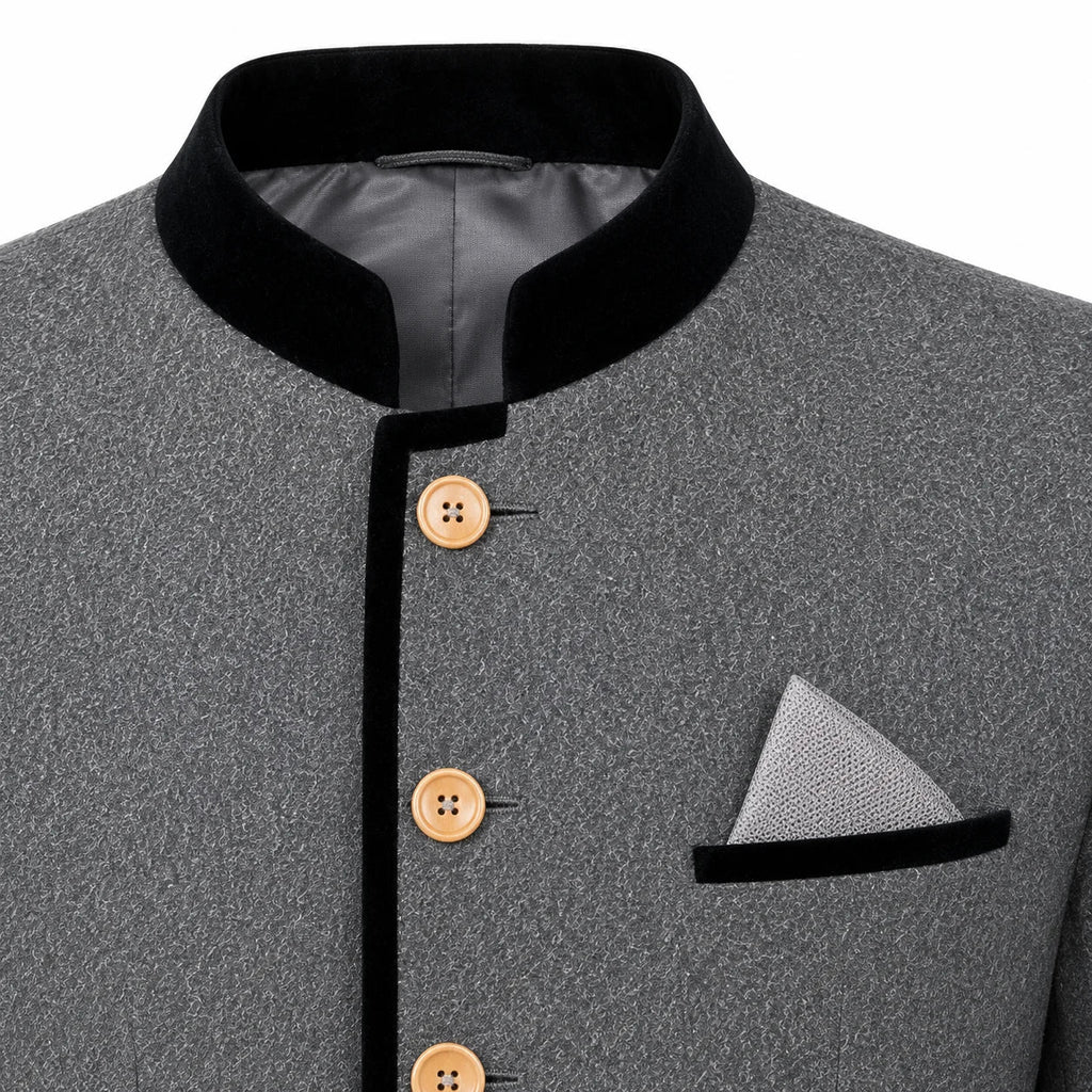 Close-up of a gray textured jacket with a black mandarin collar, black trim, and light brown buttons, featuring a matching gray pocket square with a black band.