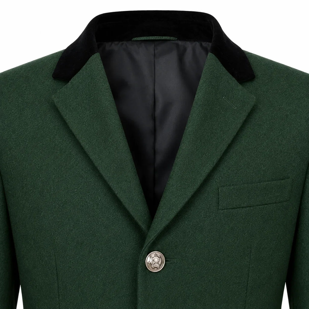 Close-up of a dark green wool-blend blazer with a contrasting black velvet collar and a silver-toned button, shown on a white background.