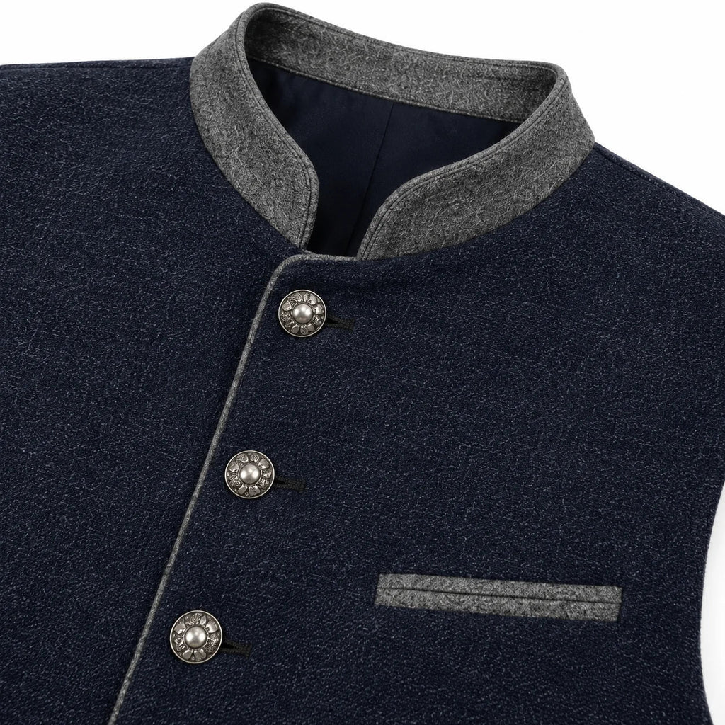 Close-up of a dark navy textured jacket with a gray mandarin collar, gray piping, and decorative silver buttons.