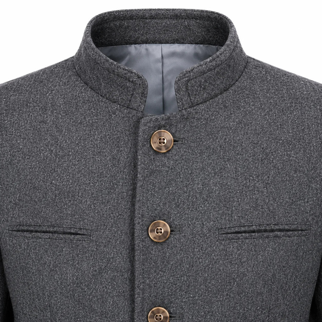 Close-up of a dark gray textured jacket with a mandarin collar, bronze buttons, and welt pockets on a white background.