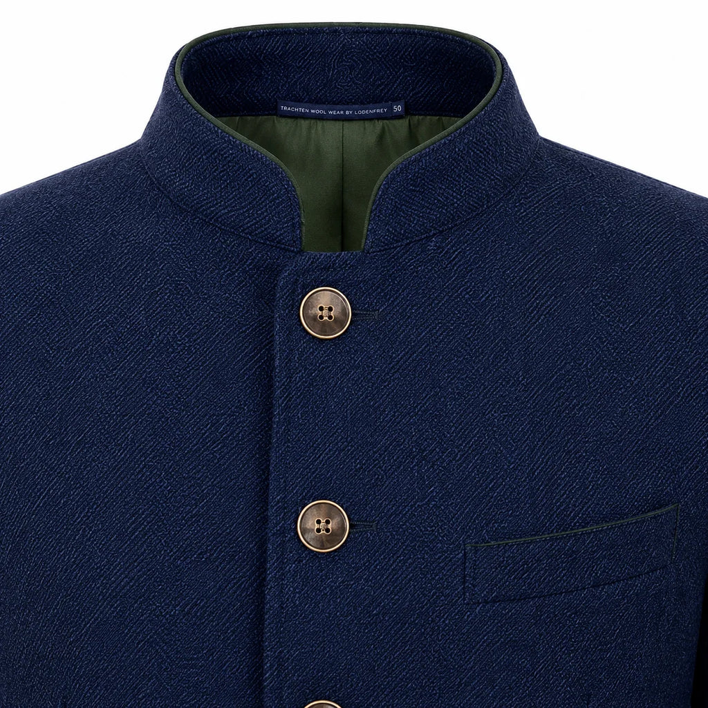 Close-up of a navy blue textured jacket with a mandarin collar, three front buttons, and a green inner lining.