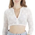 A woman wearing a white long-sleeved V-neck floral lace blouse with a snug fit.